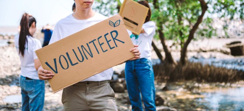 person holding a volunteer sign