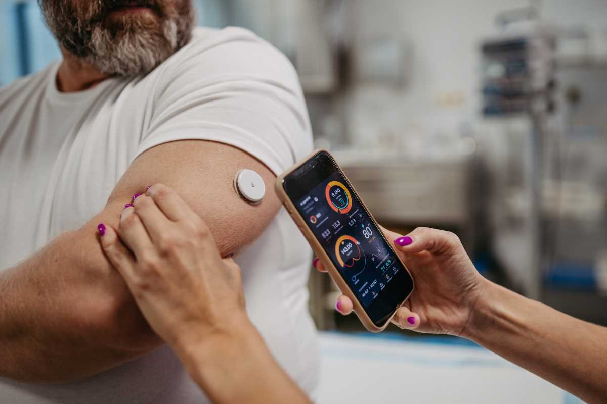 doctor connecting continuous glucose monitor